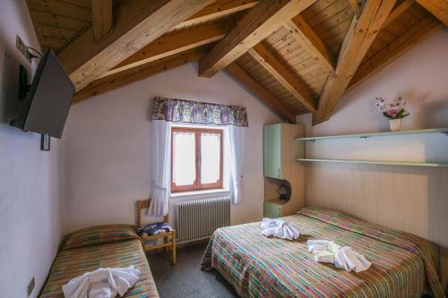 Postel nebo postele na pokoji v ubytování Hotel Aurora