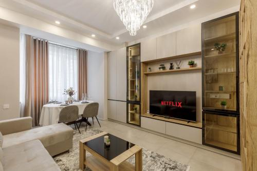 a living room with a couch and a tv at Renest Vienna Moodspace in Chişinău