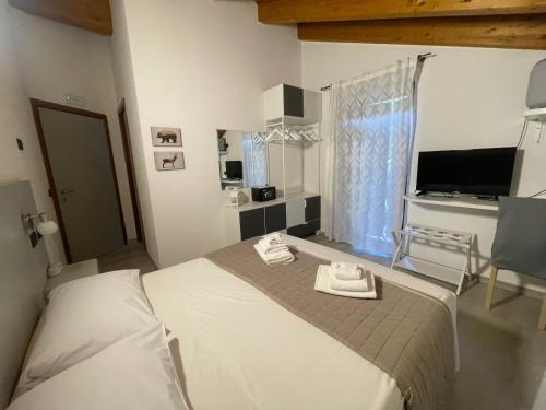 a bedroom with a bed with two towels on it at Hotel Ristorante Franca in Tovo di Sant'Agata