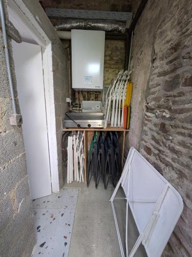 a kitchen with a counter and chairs in a room at La Jeannette in Vains