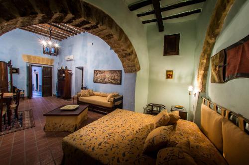 a bedroom with a bed and a living room at Le Porte del Tempo in Mazara del Vallo