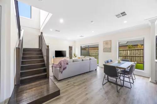 a living room with a white couch and a table at New Family Beach Home Near Geelong, St Leonards in Saint Leonards