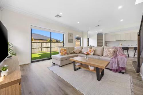 a living room with a couch and a table at New Family Beach Home Near Geelong, St Leonards in Saint Leonards