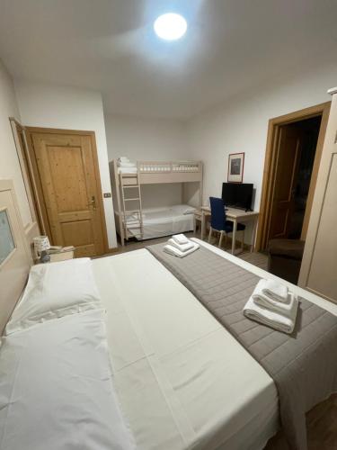 a bedroom with a large bed with two towels on it at Hotel Ristorante Franca in Tovo di Sant'Agata