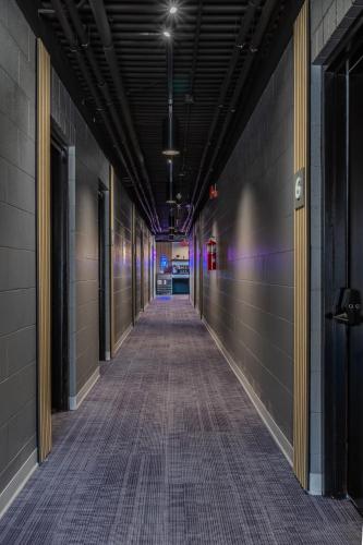 an empty hallway in a building with purple lights at The Mulberry in Logan
