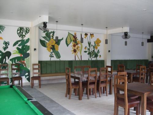 a restaurant with tables and a pool table at Calicoan Villa in Sarog