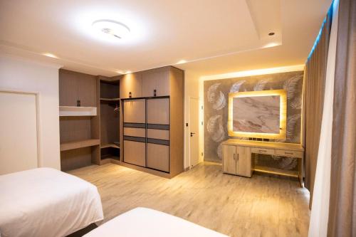 a small room with a bed and a mirror at Chic, comfortable house for Rent with Honore Rwanda in Kigali