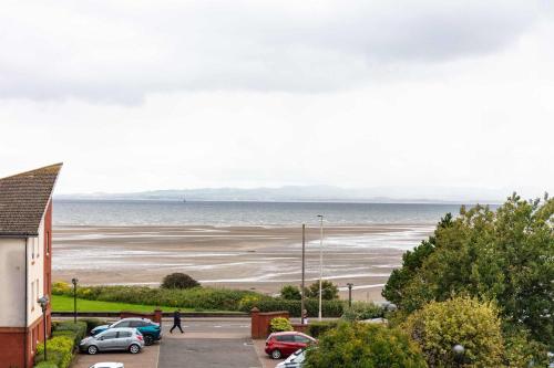 a view of a beach with cars parked in a parking lot at The Portland Penthouse - Donnini Apartments in Troon