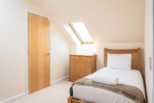 a bedroom with a bed and a skylight at The Portland Penthouse - Donnini Apartments in Troon
