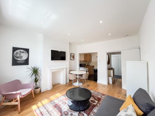 a living room with a couch and a table at Spacious Camden Apartment D1 in London
