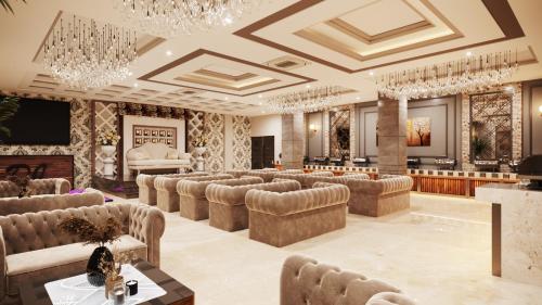 a large room with couches and a stage at Solace Suites Hotel & Banquets in Barog
