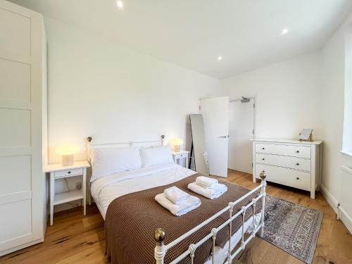 a bedroom with a bed with two towels on it at Spacious Camden Apartment D1 in London