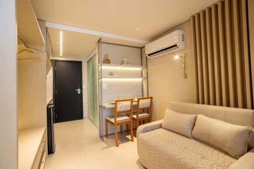 a small living room with a couch and a table at Alta Garden Housi João Pessoa by Carpediem in João Pessoa