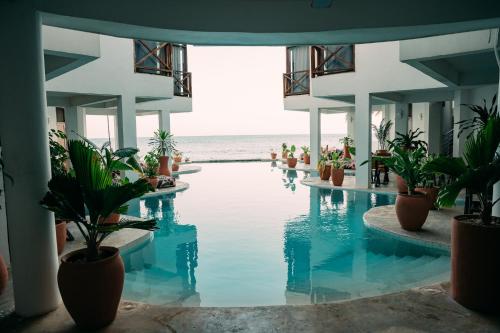 a swimming pool with a view of the ocean at ZAN Tropical Island in Bwejuu