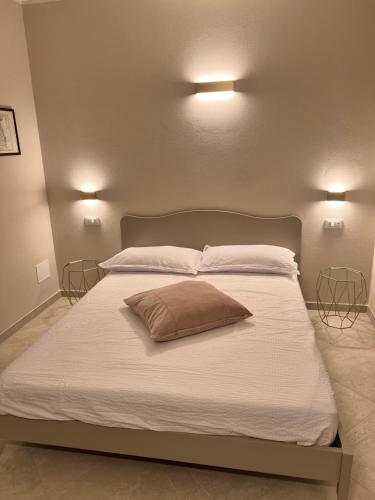 a bedroom with a large white bed with two lamps at Emilia381 Suite in Anzola dell'Emilia