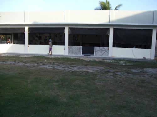 a woman standing in front of a building at Calicoan Villa in Sarog