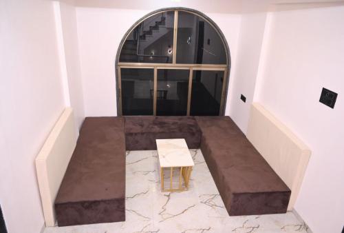a room with a table and a window at Twilight Stays ll R Villa 3BHK ll Swimming Pool ll AC ll BBQ in Lonavala