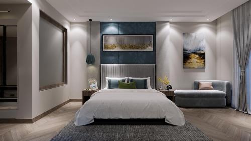 a bedroom with a large bed and a chair at Solace Suites Hotel & Banquets in Barog