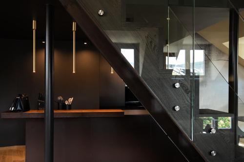 a staircase in a house with black walls at KODERLE SUITE K5 Stella Alpina in Brunico