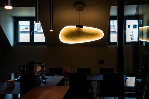a dining room with a table and a light fixture at KODERLE SUITE K5 Stella Alpina in Brunico