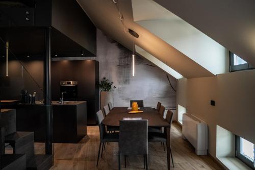 a dining room with a table and chairs at KODERLE SUITE K5 Stella Alpina in Brunico