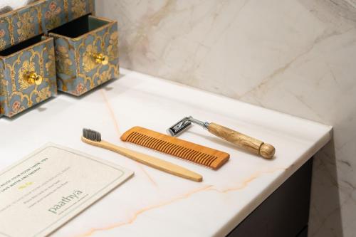 a table with a toothbrush and a razor and a comb at Taj Deccan in Hyderabad