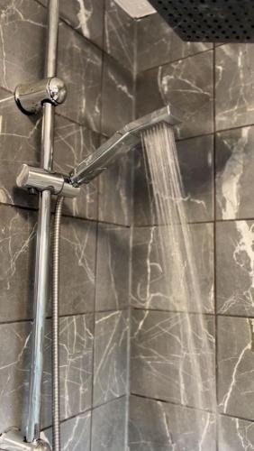a shower in a bathroom with a shower at Mona's Home in Dagenham