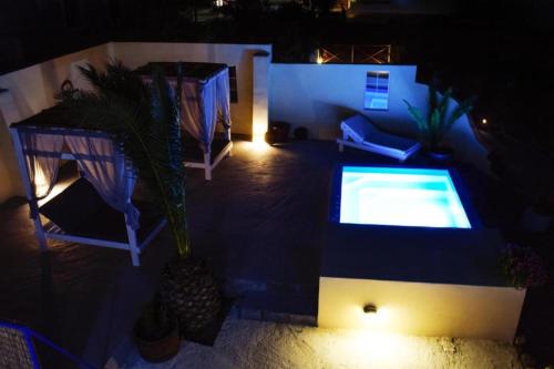 an overhead view of a swimming pool at night at Marina's Studios in Perivolos