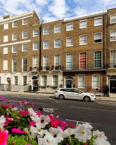 a white car parked in front of a building at Upper Berkeley Hotel in London