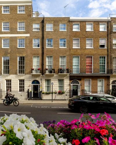 a man riding a motorcycle in front of a building at Upper Berkeley Hotel in London