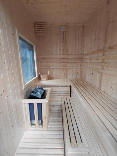 a wooden sauna with a bench in the middle at Cóc Retreat Mỹ Tho City in My Tho