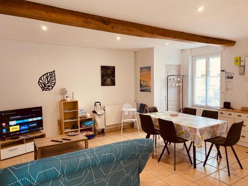 a living room with a blue couch and a table at La Maison de Pêcheur in Étaples