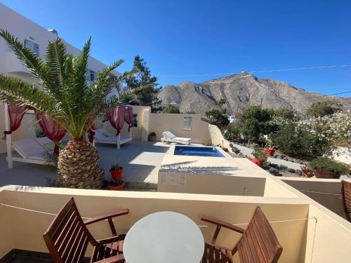 a view of a house with a palm tree and a pool at Marina's Studios in Perivolos
