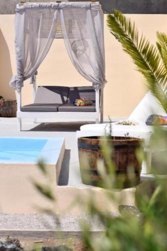 a bedroom with a bed with a canopy and a window at Marina's Studios in Perivolos