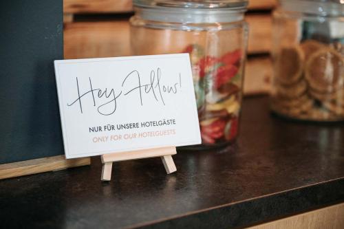 a sign sitting on top of a counter at Coffee Fellows Hotel München-Freiham in Munich