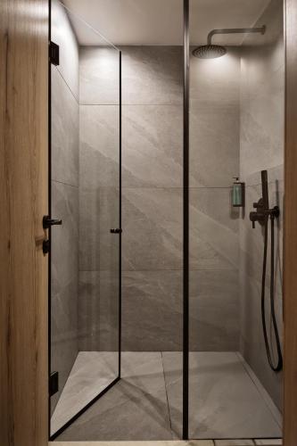 a shower with a glass door in a bathroom at Filoxenia Hotel Zakynthos in Tsilivi