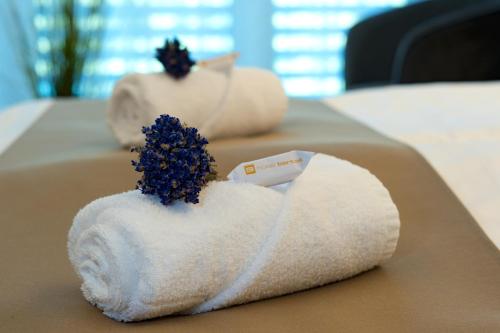 a white towel with a toothbrush in it at Hotel Bartoš in Frenštát pod Radhoštěm