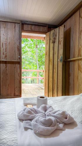 a room with a bed with a towel on it at Flor da Mata in Iranduba