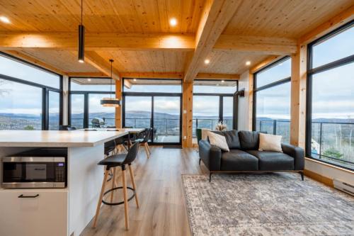 a kitchen and living room with a couch and a table at Ski Chalet with Sauna - Mountain - L'Elegant in Saint Come