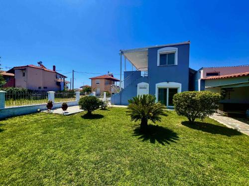 a blue house with trees in a yard at BLUE HOUSE in Karianí