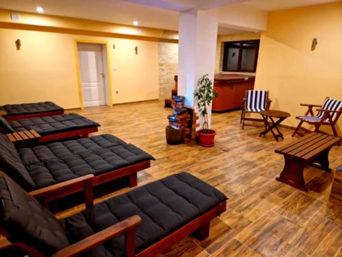 a large living room with black couches and chairs at Nordic Sunset Retreat in Pamporovo