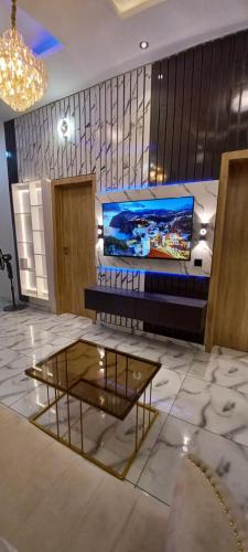 a room with a bed and a glass table at WhiteHouse Shortlet Apartments in Lagos