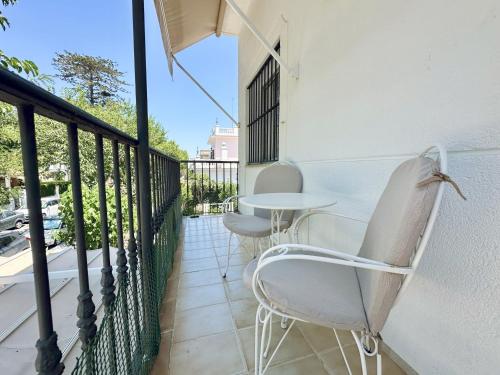 a balcony with two chairs and a table at Apartamentos Turísticos Santo Rostro in Chipiona