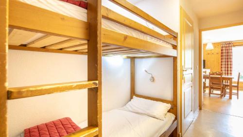 two bunk beds in a room with a table at Les Grizzlis N 20 - 2P6 in Saint-Sorlin-dʼArves