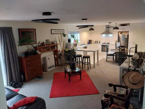 a living room with a kitchen and a living room at Coastal Retreat in Wellington - Perfect for Quick Stays in Wellington