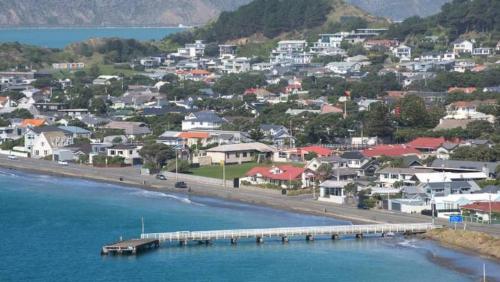 a city with houses and a bridge over the water at Coastal Retreat in Wellington - Perfect for Quick Stays in Wellington