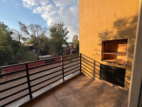a balcony with a pizza oven on the side of a building at Iguazu Lofts in Puerto Iguazú