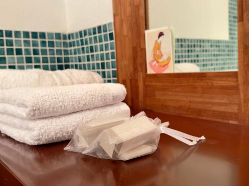 a pile of towels on a table in a bathroom at Chambre au Château in Le Vigan