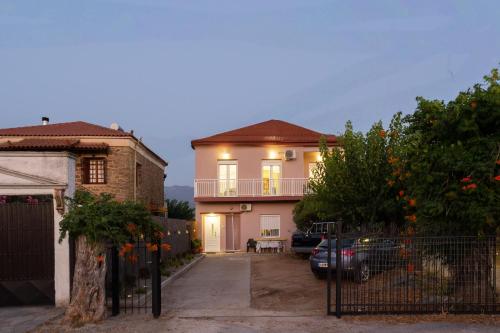 a house with a balcony and a car parked in a driveway at Valira Stathmos Home, Rustic Charm Cottage w Views in Valíra