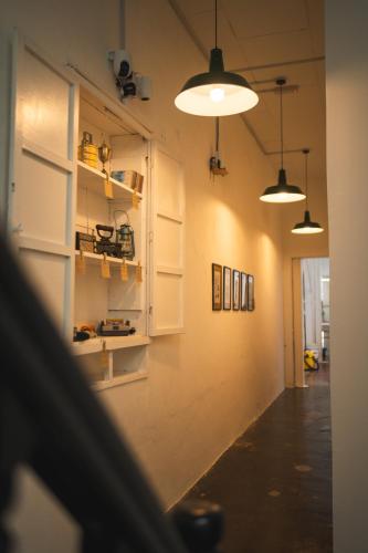 a room with white cabinets and pictures on the wall at Carnarvon 73 in George Town